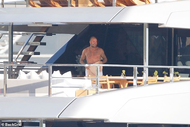 David went shirtless before slipping into a cream T-shirt for the rest of the day
