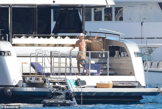 Romeo also waved out to sea after he was dropped off on the luxury vessel on a smaller boat to join his family