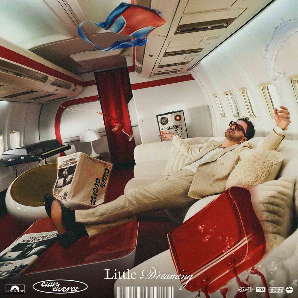 Album cover art: Man relaxing on a private jet, album title "Little Dreaming."