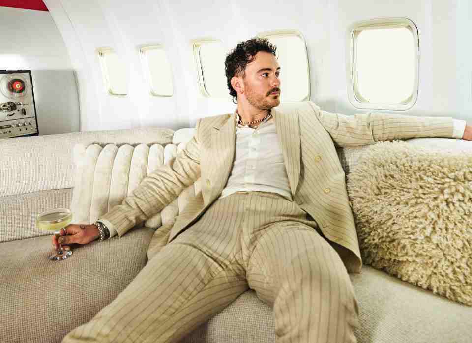 Cian Ducrot sitting on a couch in a private jet.