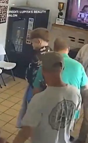 Surveillance image of a man being apprehended.