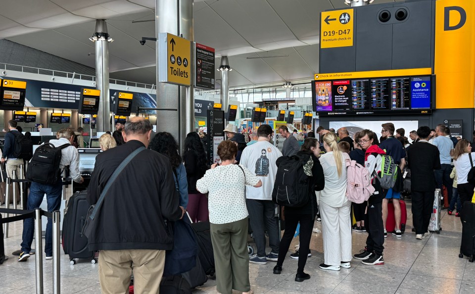 Long lines of passengers at Heathrow Airport check-in.