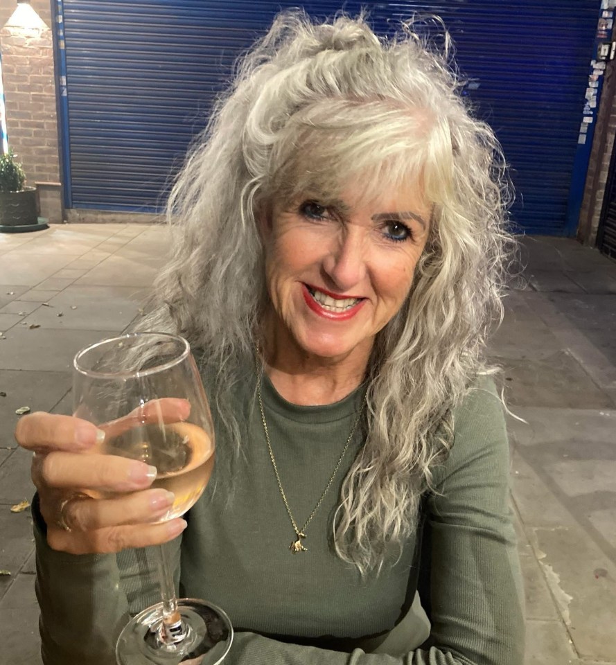 Photo of Monica Clare holding a glass of rosé.