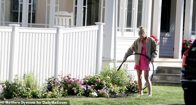 She was snapped tending to her garden and watering her plants at her two-story, four-bedroom property in Rye, New Hampshire