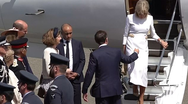 Mrs Macron did not accept Mr Macron's offer of a helping hand as she walked down the steps