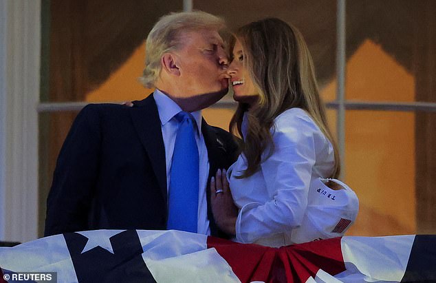 President Donald Trump (left) and first lady Melania Trump (right) smooched on the Truman Balcony ahead of the Washington, D.C. fireworks display marking the Fourth of July Friday