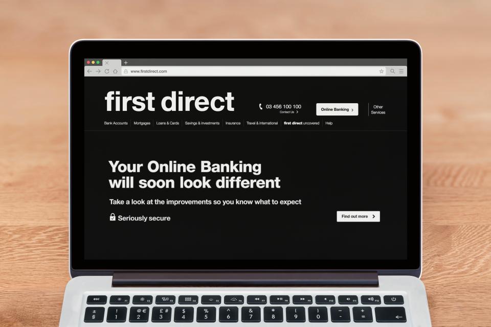 Laptop displaying First Direct online banking website update announcement.