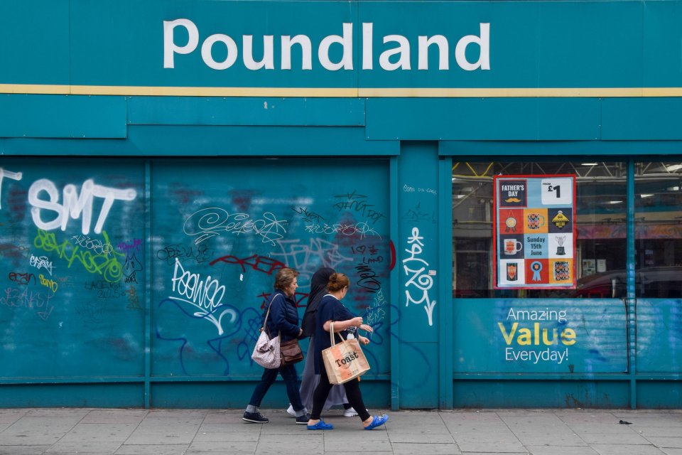 Exterior of a Poundland store with graffiti.