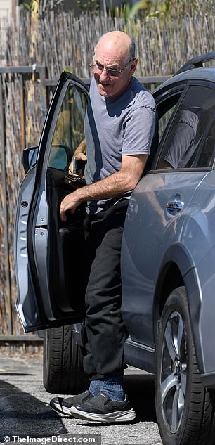 He wore it with black sweatpants and matching trainers