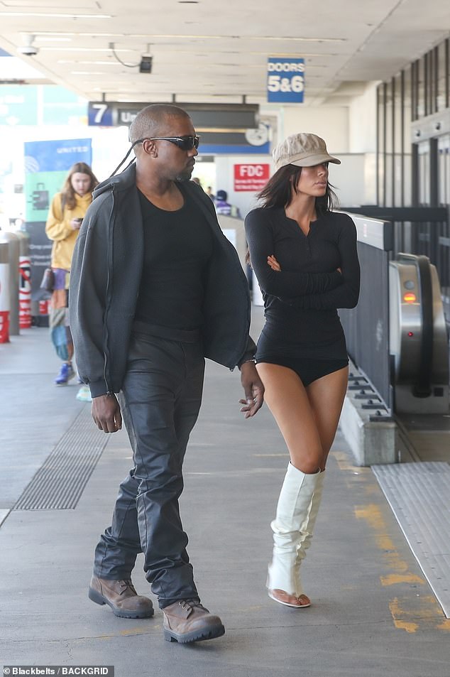Kanye West, 48, and wife Bianca Censori, 30, turned heads as they were pictured making their way through Los Angeles International Airport on Thursday to catch a commercial flight