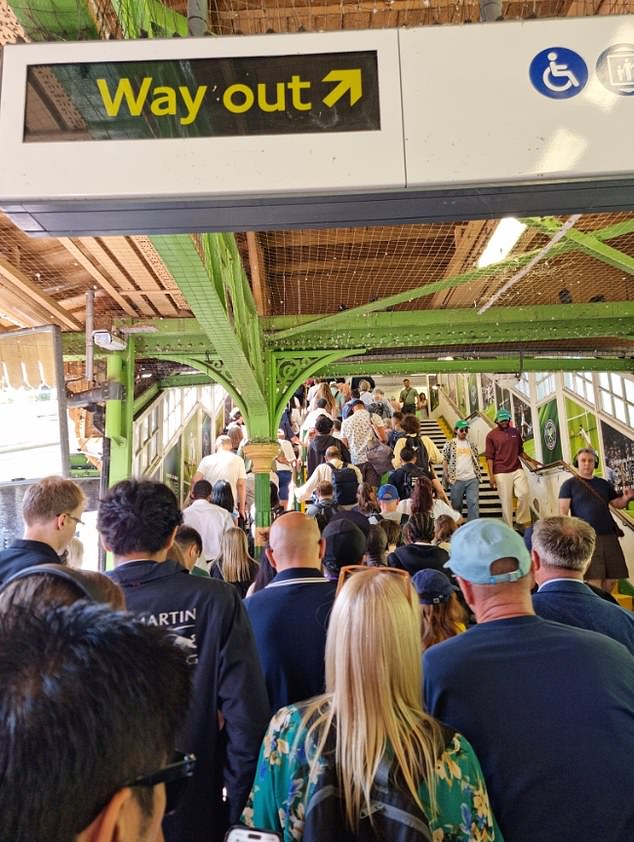 Wimbledon fans queue to get out of Southfields station on the London Underground yesterday
