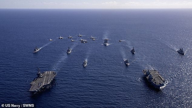 During its eight-month mission to the Far East, HMS Prince of Wales (right) joined USS George Washington (left) in the Timor Sea on Friday, July 18 in a bid to help reaffirm Britain's Indo-Pacific commitments amid growing tension with Beijing