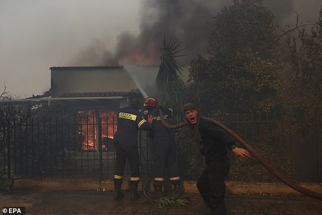 British tourists have been put on alert as new Greece wildfires spread amid a 44C heatwave - as a blaze tears through the capital of Athens. Pictured: Firefighters and volunteers battle to put out a fire burning a house in Kryoneri, near Athens, on Saturday