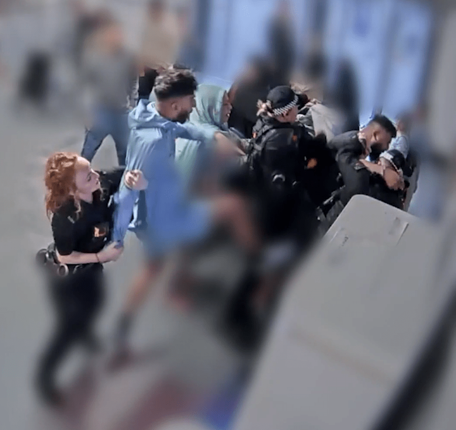 Police officers arresting a man.