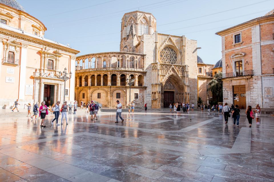 Valencia Cathedral square with people.
