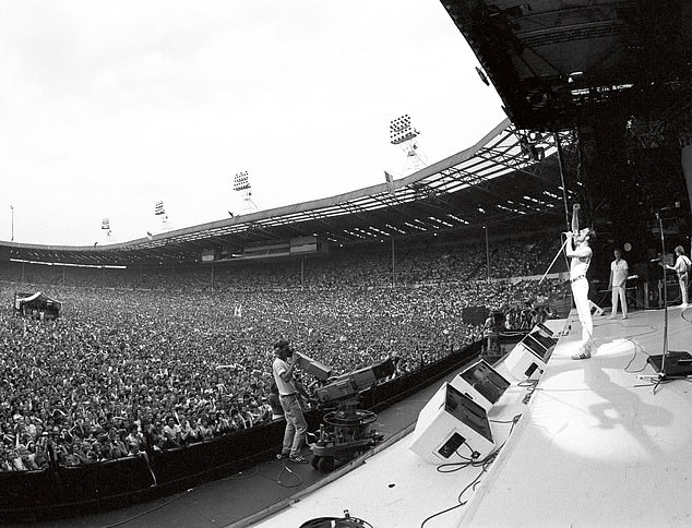 Queen frontman Freddue Mercury serenades the crowd during the band's legendary Live Aid performance in 1985