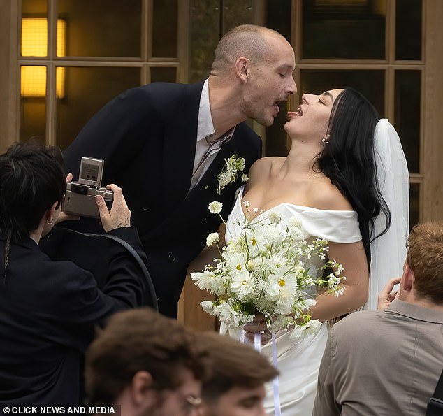 Charli and George put on a very saucy display as they posed for snaps with family and friends as they smooched for all to see