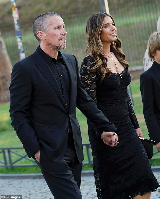 Christian Bale (pictured) and Erling Haarland look classically handsome as they brought their partners to the Dolce & Gabbana Alta Moda fashion show on Monday