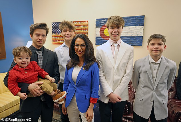 Lauren Boebert (center) with Tyler (far left) holding his son. In a statement, she said: 'Unfortunately, this event stems from a miscommunication on monitoring my young grandson that recently led to him getting out of our house'