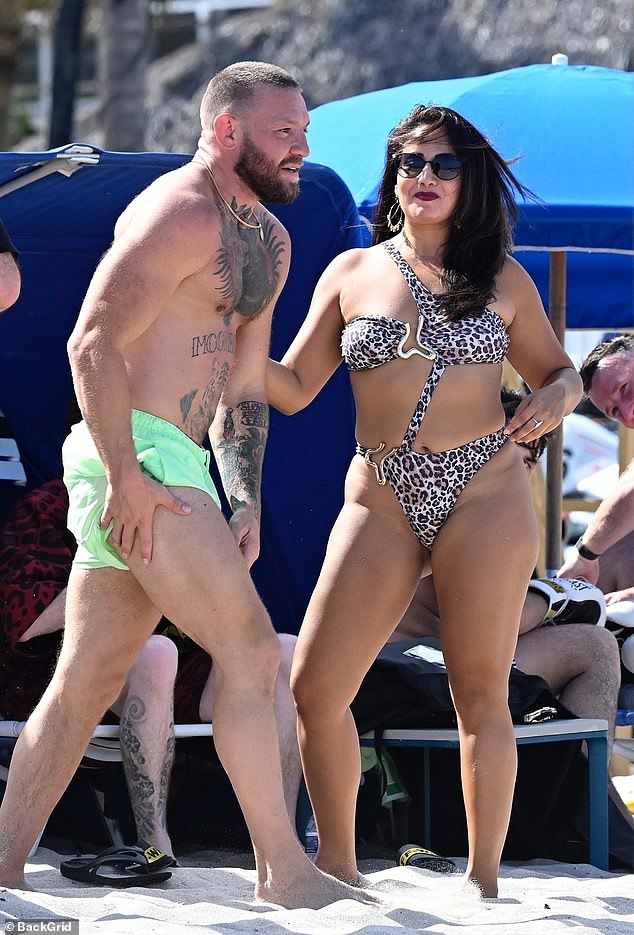 McGregor showed off his muscular physique in a pair of short green swimming trunks