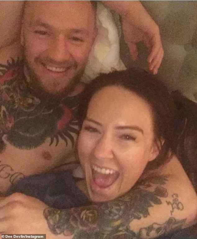 Conor McGregor's fiancee (pictured with the sportsman) has spoken out after he was pictured kissing a mystery woman