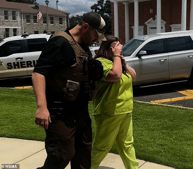 Rebecca Brewer, one of the seven adults charged in connection to alleged horrid child abuse, was seen covering her face with her shackled hands, telling reporter: 'I didn't do this. I love my babies' outside of court Thursday
