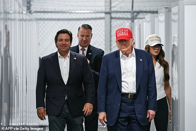 US President Donald Trump (centre), flanked by Florida Governor Ron DeSantis (far left), and Secretary of Homeland Security Kristi Noem (right), tours a migrant detention centre dubbed 'Alligator Alcatraz earlier this month. Trump boasted about it being policed by an unseen army of man-eaters, saying: 'We're surrounded by miles of treacherous swampland'