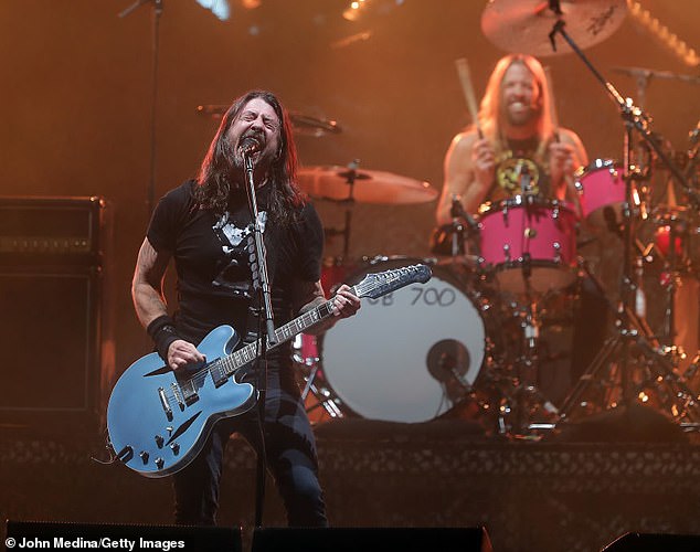 Foo Fighters frontman Dave Grohl (M, pictured in 2022) penned an emotional six-page letter in honor of his rock band's 30th anniversary, in which he paid tribute to his late bandmate Taylor Hawkins (R)