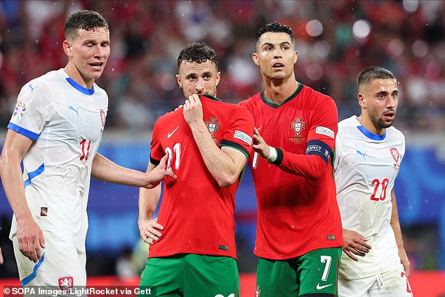Cristiano Ronaldo and Diogo Jota stand together during their UEFA Euro 2024 match agaisnt the Czech Republic in June last year. The Portugal captain did not attend his teammate's funeral in Gondomar on Saturday