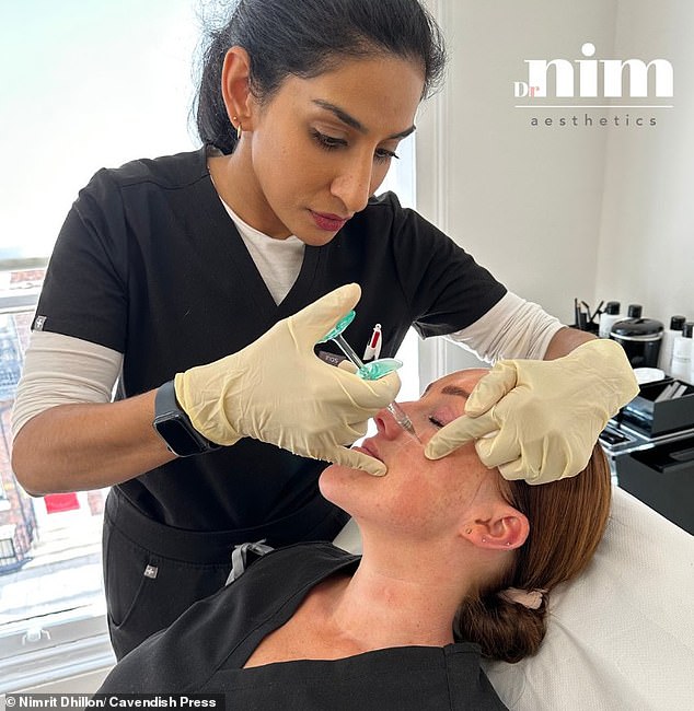 Last November at the Medical Practitioners Tribunal Service, Dhillon suspended from practice for eight months (file image of her working on a patient)
