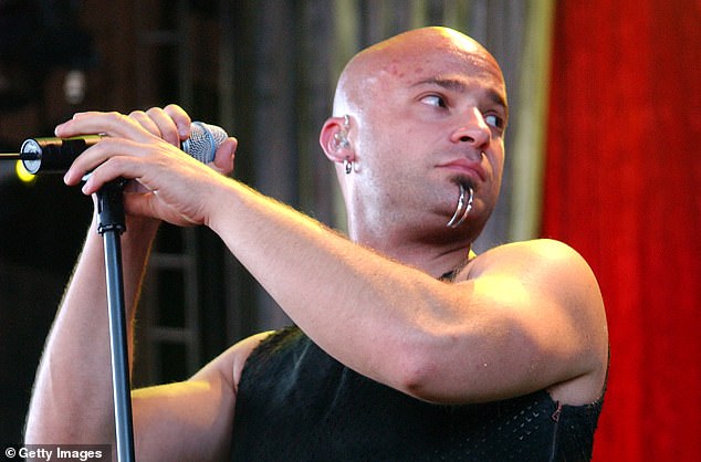 Rock band Disturbed frontman David Draiman was booed while he played a support slot at Ozzy Osbourne 's and Black Sabbath's last live show. Pictured: David Draiman of Disturbed performs during Ozzfest 2003