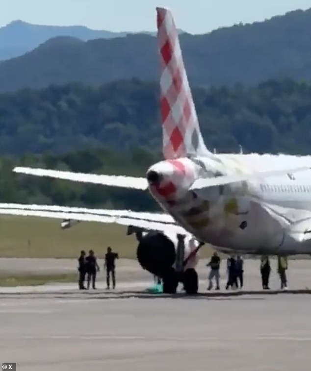 Footage from the runway appears to show people surrounding the aircraft around the time of the accident
