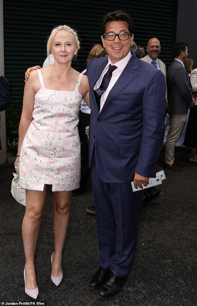 Michael McIntyre cosied up to leggy wife Kitty as they attended day eight of Wimbledon at The All England Lawn Tennis Club on Monday