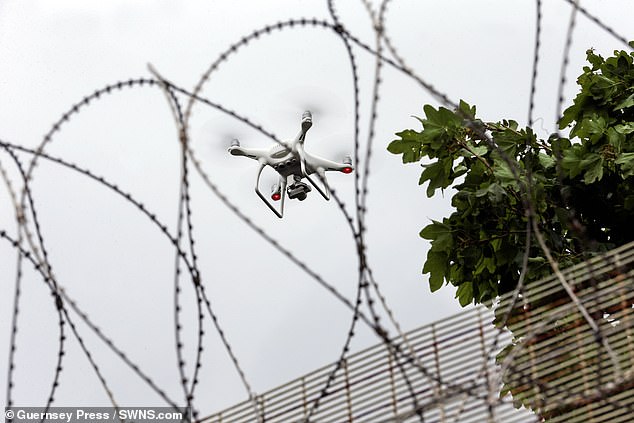 Drones could carry escaping prisoners over jail walls, the watchdog's chief inspector has warned (pictured: a drone hovering over Guernsey prison)