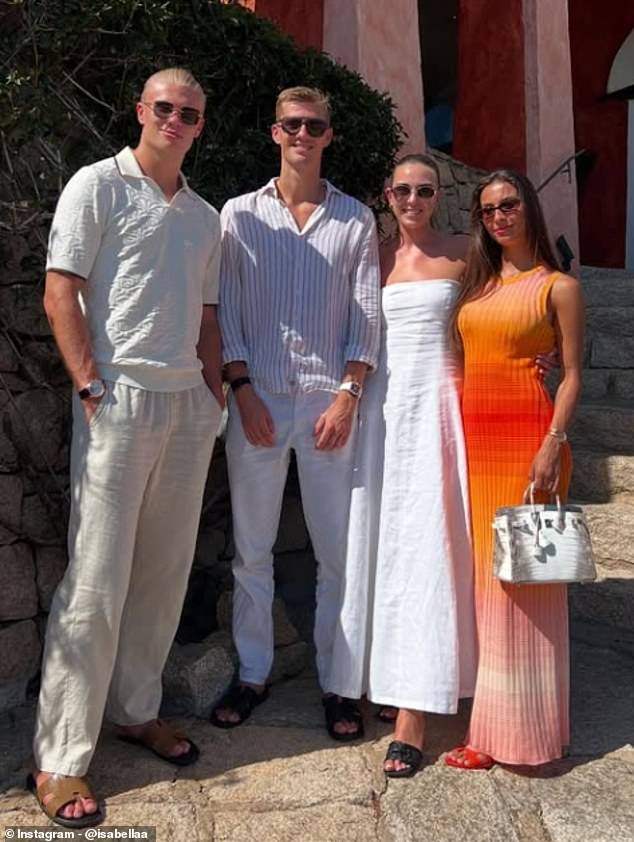 She can also be seen in a group shot with the Manchester City striker and his brother Astor