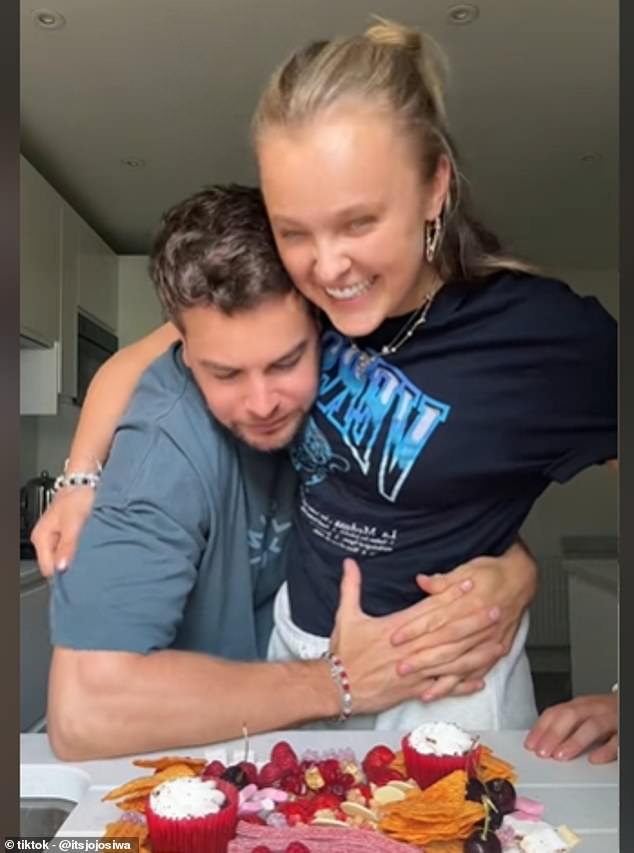 JoJo Siwa and Chris Hughes sparked pregnancy rumors with this viral on TikTok this month. He was seen gently rubbing her stomach for a couple seconds