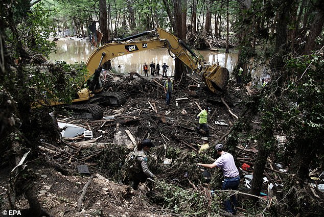 The floods ravaged Kerr County as the death toll topped 100 victims, many of which were children (Pictured: First responders looking for survivors and remains)