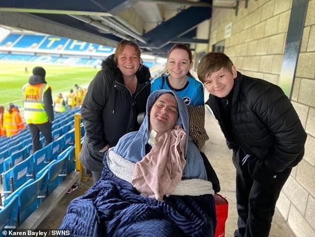 He has regained facial expressions, his wife shared, as seen with him smiling in a photograph of the family at a football game
