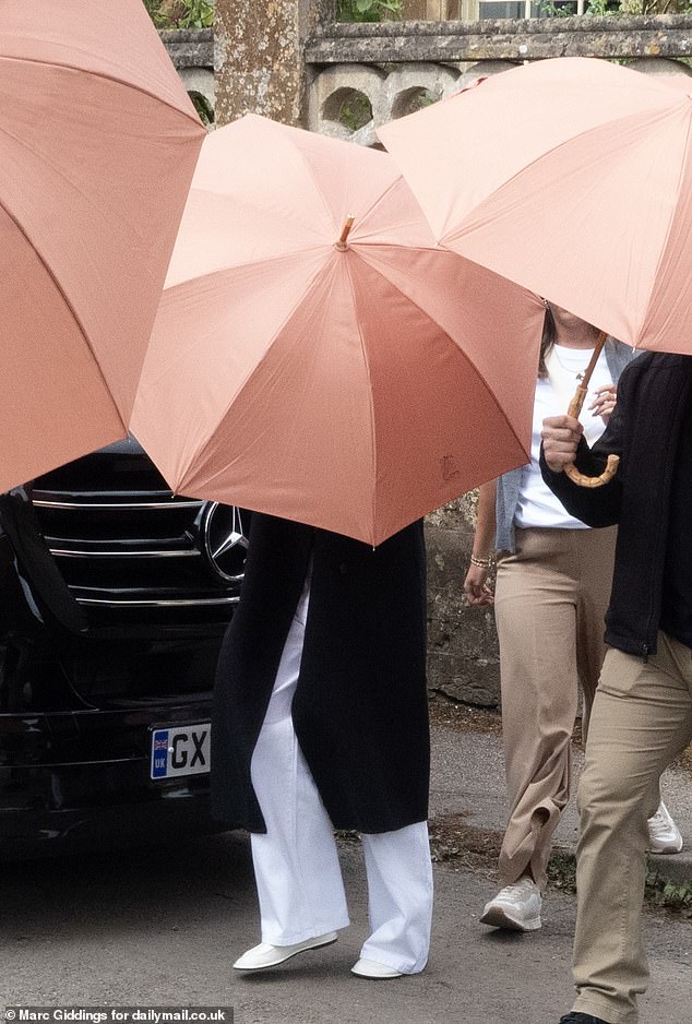 Apple heiress Eve Jobs has gone through some of the final preparations for her society wedding of the year, carrying out a complete church ceremony rehearsal of her marriage to Team GB showjumper Harry Charles on Thursday morning. Pictured, Eve is believed to be the chic bride standing behind the umbrella