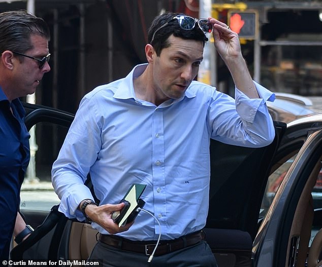 Evan LePatner, 44, is pictured arriving at his Upper East Side apartment building the day after the murder of his wife Wesley