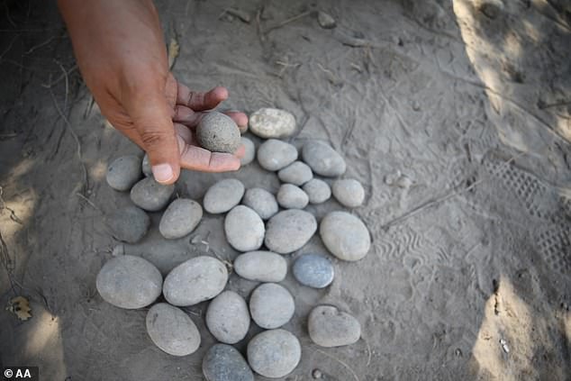According to the archeologists, sling stones were common battlefield weapons in the Bronze Age, and their concentrated presence points to a siege, not a peaceful decline