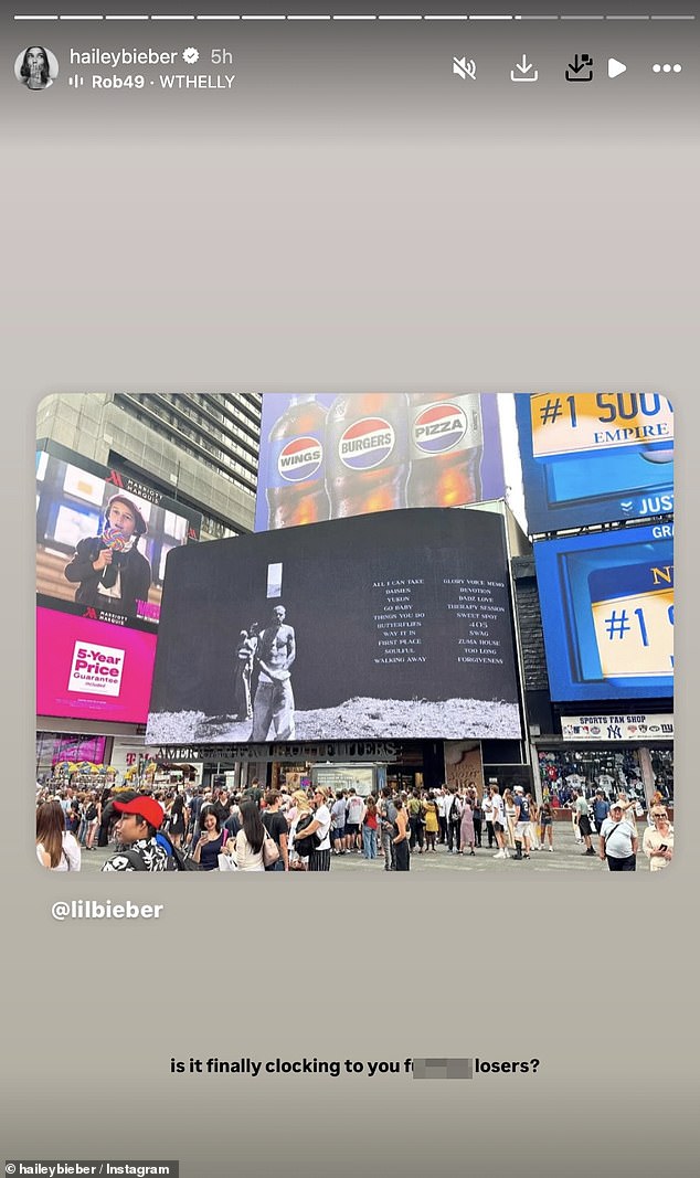 Hailey appeared to take aim at the 'losers' who have speculated about their marriage as she re-posted a photo of Justin's massive Swag billboard in NYC 's Times Square