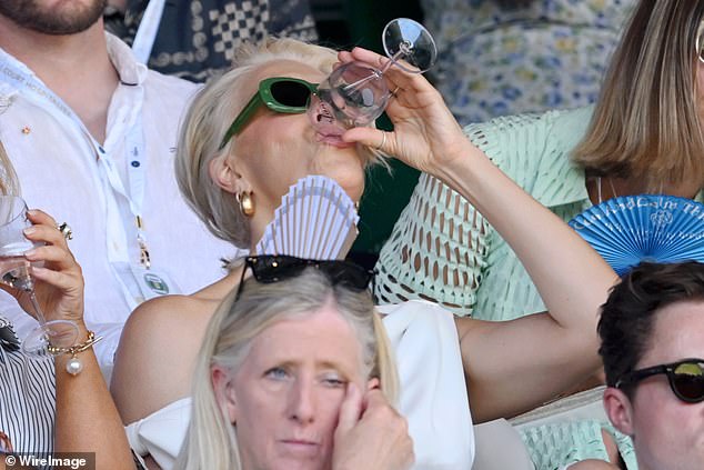 Hannah Waddingham, 50, downed a glass of wine as she sat Centre Court watching the match at day 12 of Wimbledon