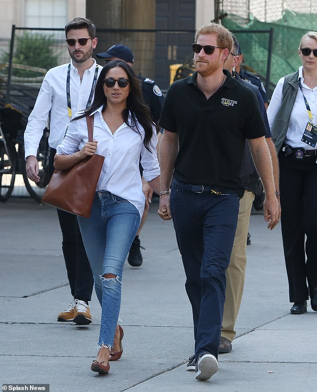 Jason Knauf (left) is pictured with Harry and Meghan attending the Invictus Games in Toronto. He accused Meghan of bullying staff and then quit the royal household after Megxit