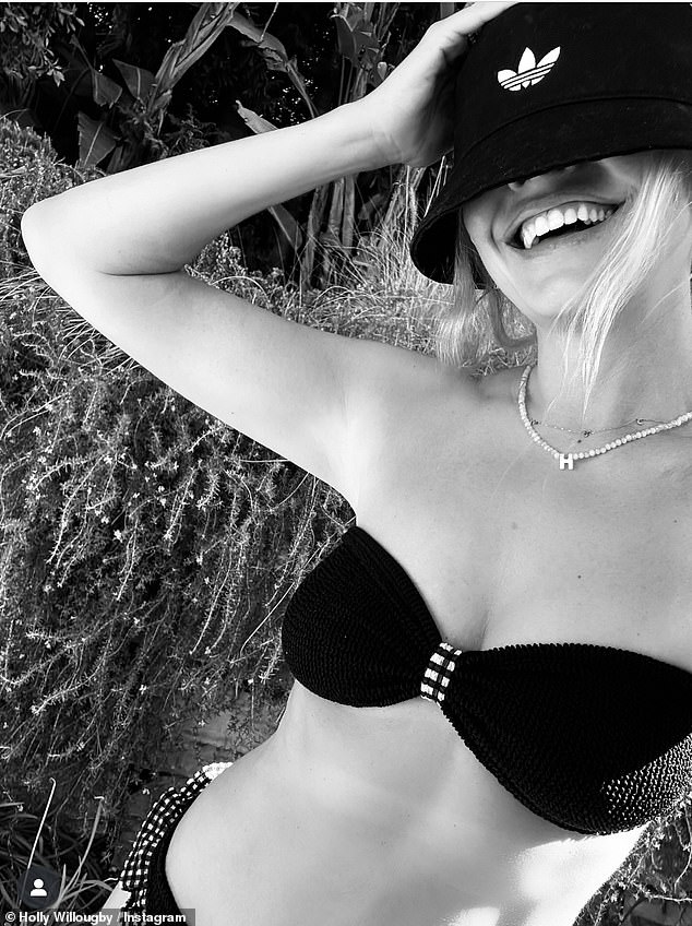 Holly Willoughby turned heads as she posted a rare bikini snap on Saturday along with a message for Oasis fans ahead of the bands second gig at Wembley