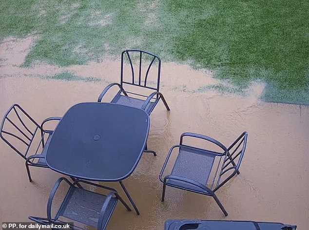 Every time it rains water swamps their patios, almost lapping into the house in extreme cases. Pictured: Dean Hodgson's garden