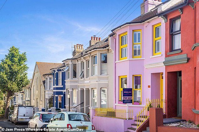 The property, which has been likened to 'Polly Pocket's home', is immediately visible from the road sporting a baby pink exterior with bright yellow accents
