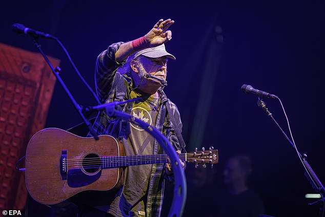 Rock legend Neil Young (pictured at Montreux Jazz Festival last week) has opened up about his secret family heartache - after claiming he has been banned from seeing his two young grandchildren