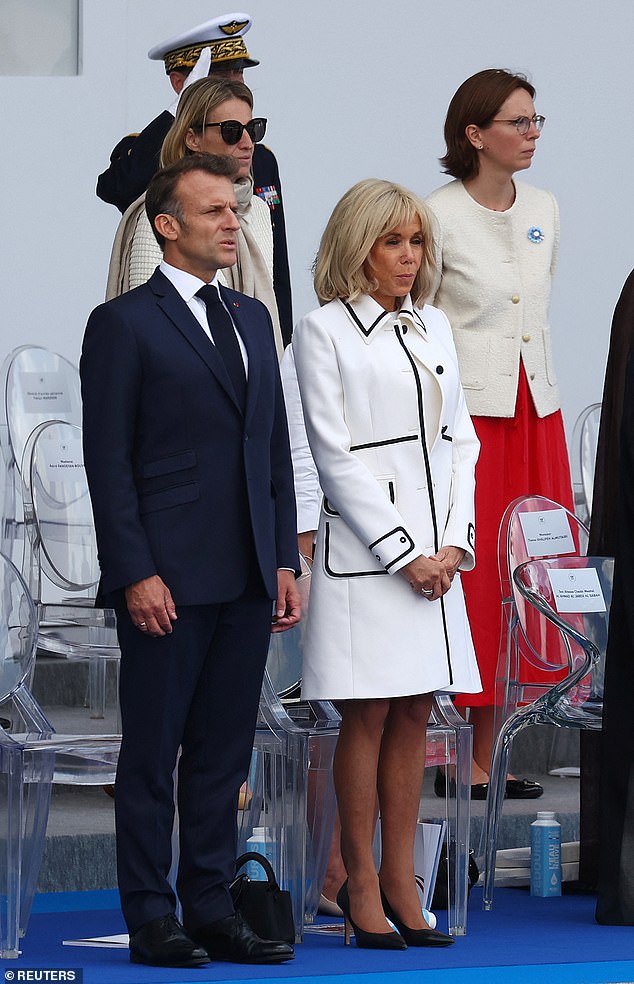 Brigitte Macron stands at her husband's side at the Place de la Concore in Paris, on July 14