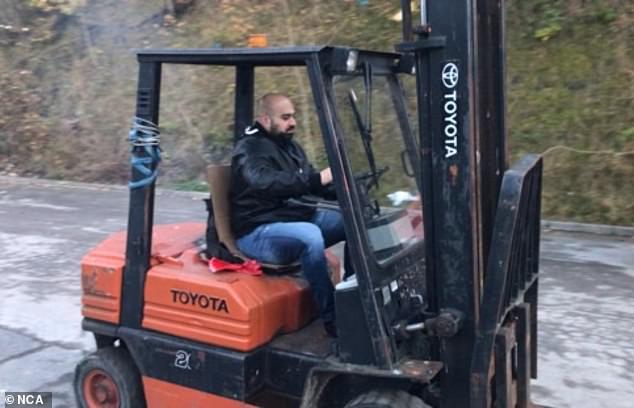 An photo obtained from EncroChat showing Tahir Syed, 42, driving a forklift truck
